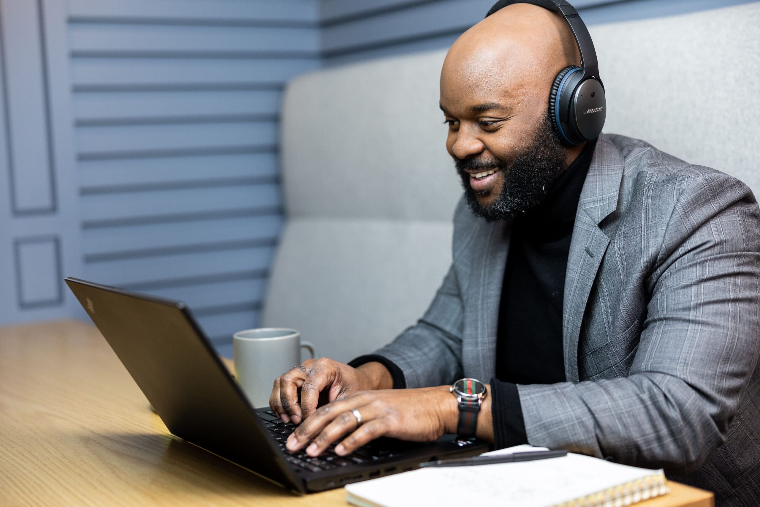 Man with headphones on on a laptop