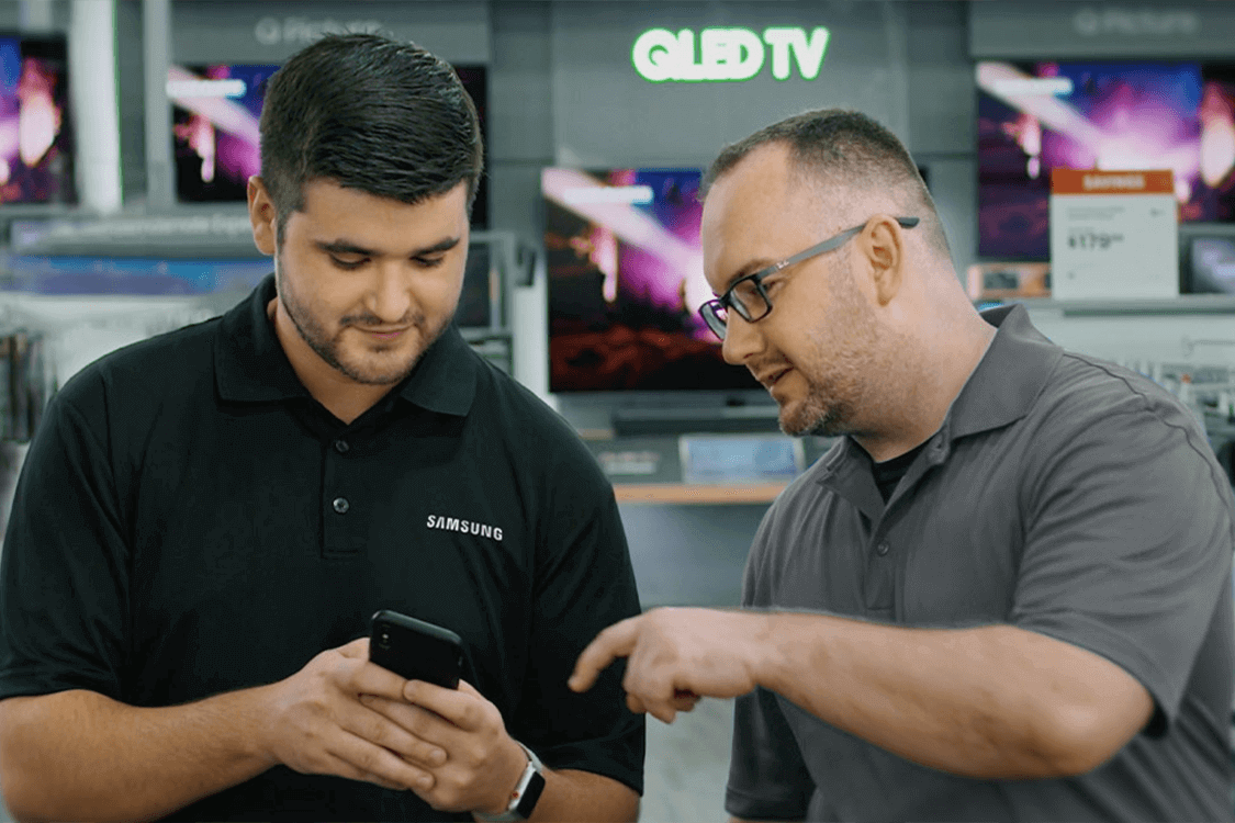 Two men looking at a phone