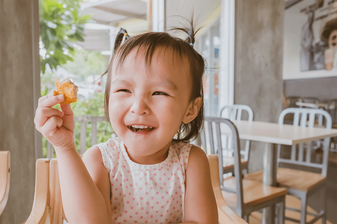 Child holding a chicken nugget