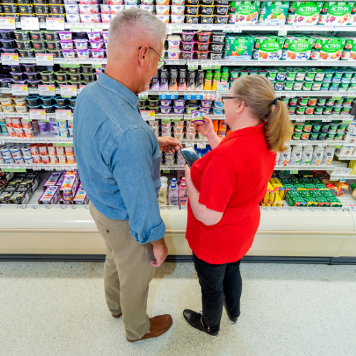 Two people standing in an aisle